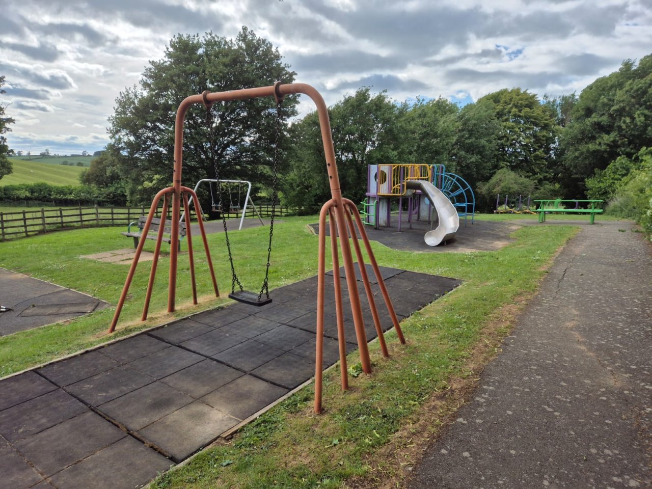 Uneven and damaged ground surface of play area.